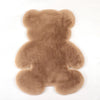 A plush bear-shaped non-slip area rug in a light brown color.