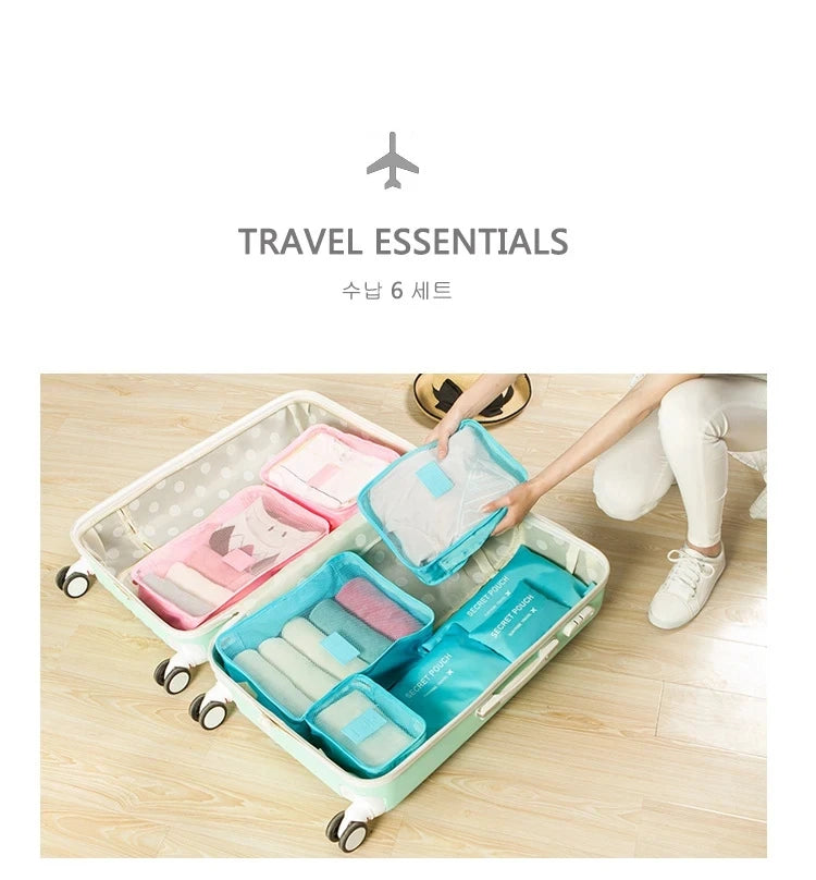 A light blue and pink travel organizer storage set with various pouches and accessories is shown in a suitcase.