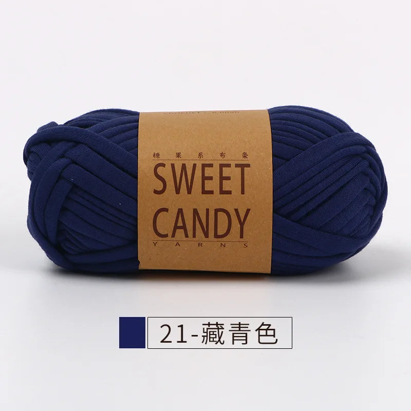 A skein of dark blue hand-dyed yarn labeled Sweet Candy yarns.