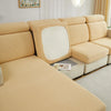 A beige jacquard elastic sofa cushion slipcover on a light-colored sofa with a mirrored accent.