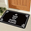 Black doormat with white text that reads Take Off Your Shoes Please and features a crown design