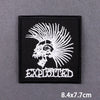 Black embroidered patch featuring a white skull with radiating spikes and the word EXPLOITED below