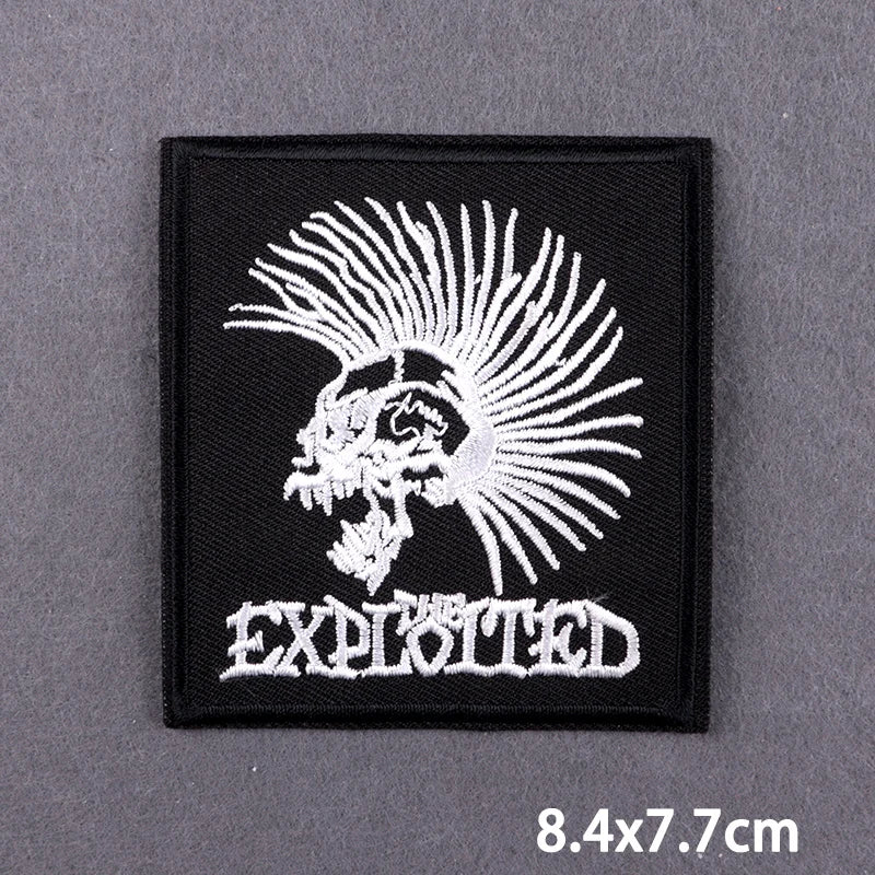 Black embroidered patch featuring a white skull with radiating spikes and the word EXPLOITED below
