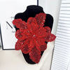 A vibrant red 3D floral fabric applique patch made of sequin lace displayed on a black mannequin.