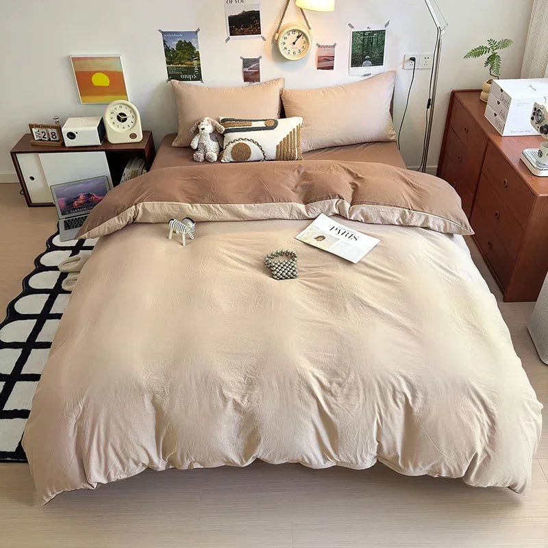 A beige quilt bedding set with decorative pillows and a white wooden headboard in a bright room.