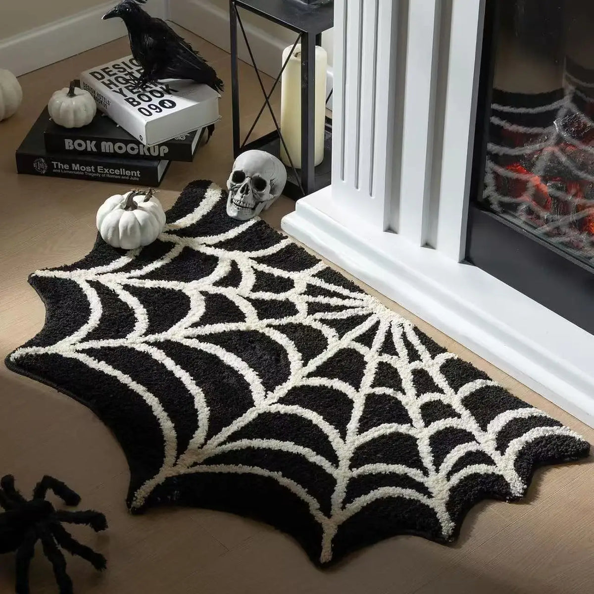 A black and white decorative non-slip foot mat with a spiderweb pattern displayed on a wooden surface.
