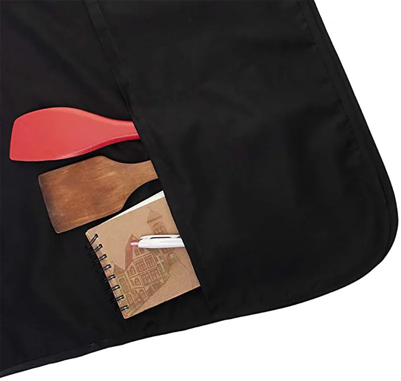 Black apron with wooden and red tools placed on the fabric for crafting or kitchen use