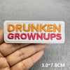 White embroidered patch with orange text reading DRUNKEN GROWNUPS