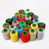 A collection of handmade sewing threads in various colors and shades arranged in a pyramid formation.