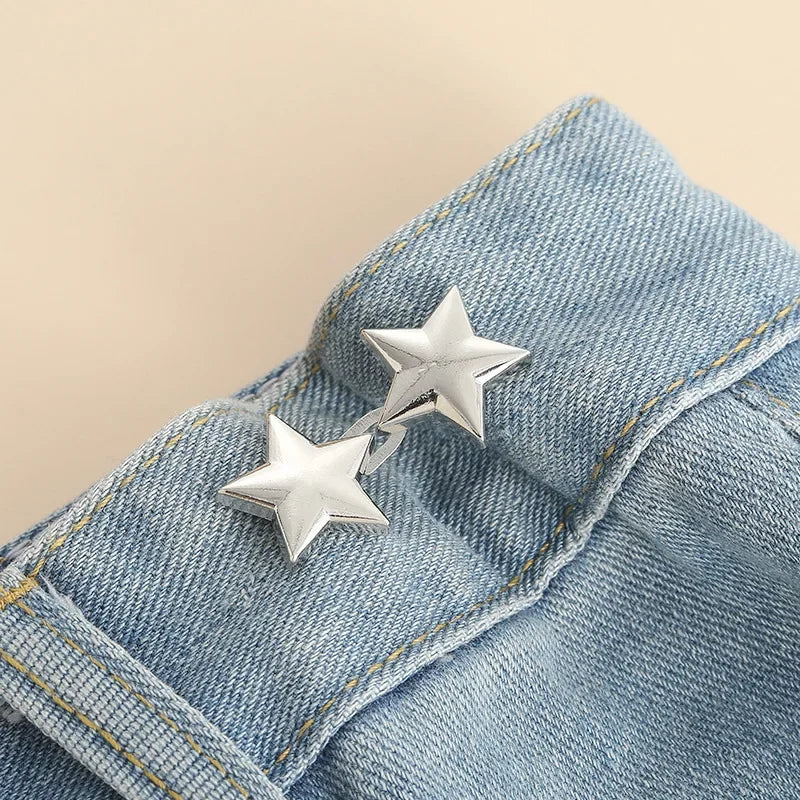 Silver star-shaped button clips attached to a blue denim fabric