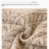 Close-up of a beige and brown herringbone textured fabric used for a sofa cover.