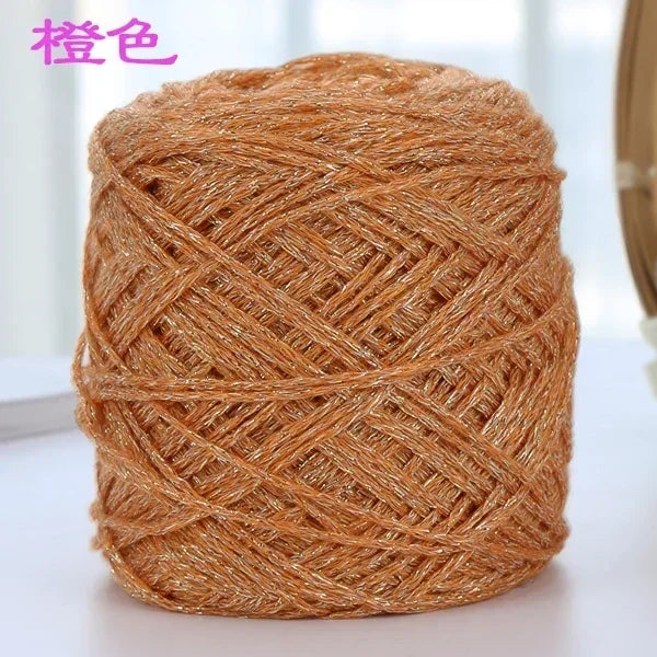 A ball of metallic copper colored silk yarn used for crocheting and knitting