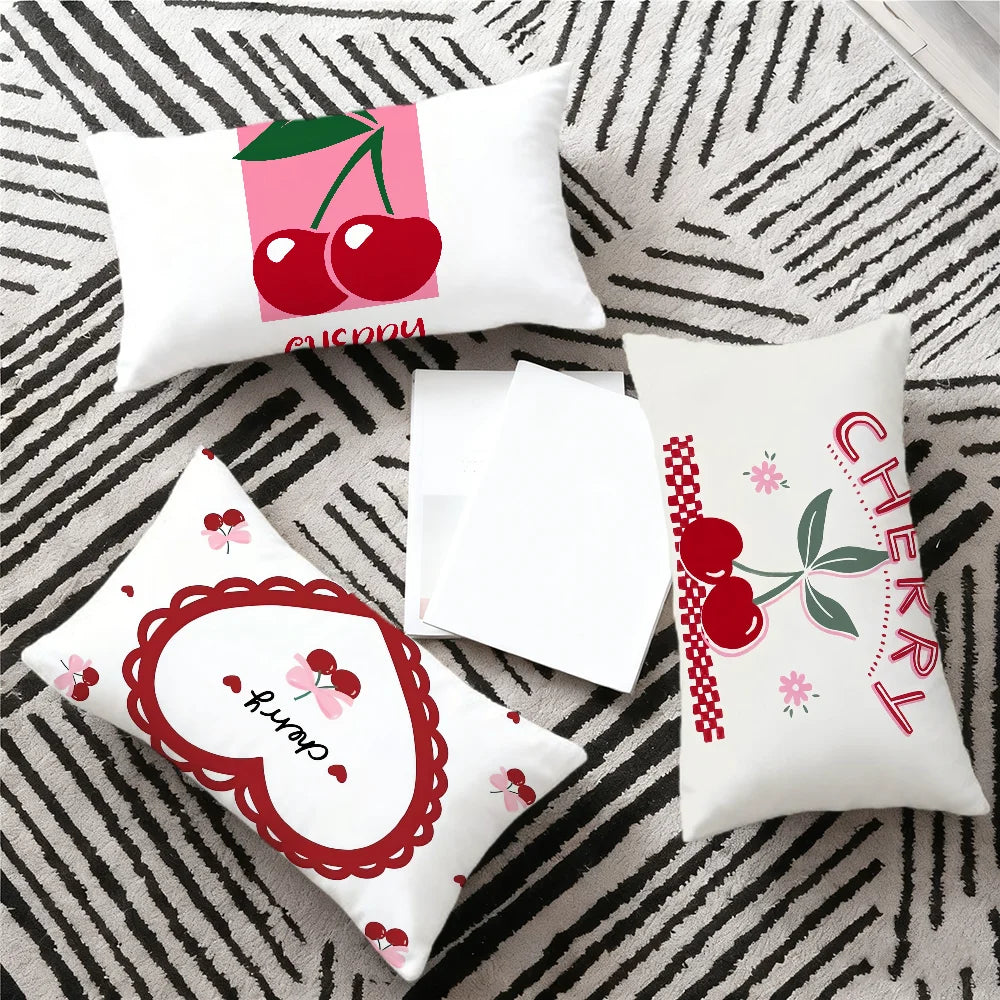 A set of pink and red cherry themed cushion covers featuring cute anime cartoon designs on a gray striped fabric.