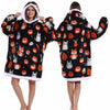 A woman models an oversized patchwork fleece hoodie featuring various animal patches in black and white.