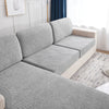 Gray splashproof jacquard sofa cushion covers on a light-colored sofa.
