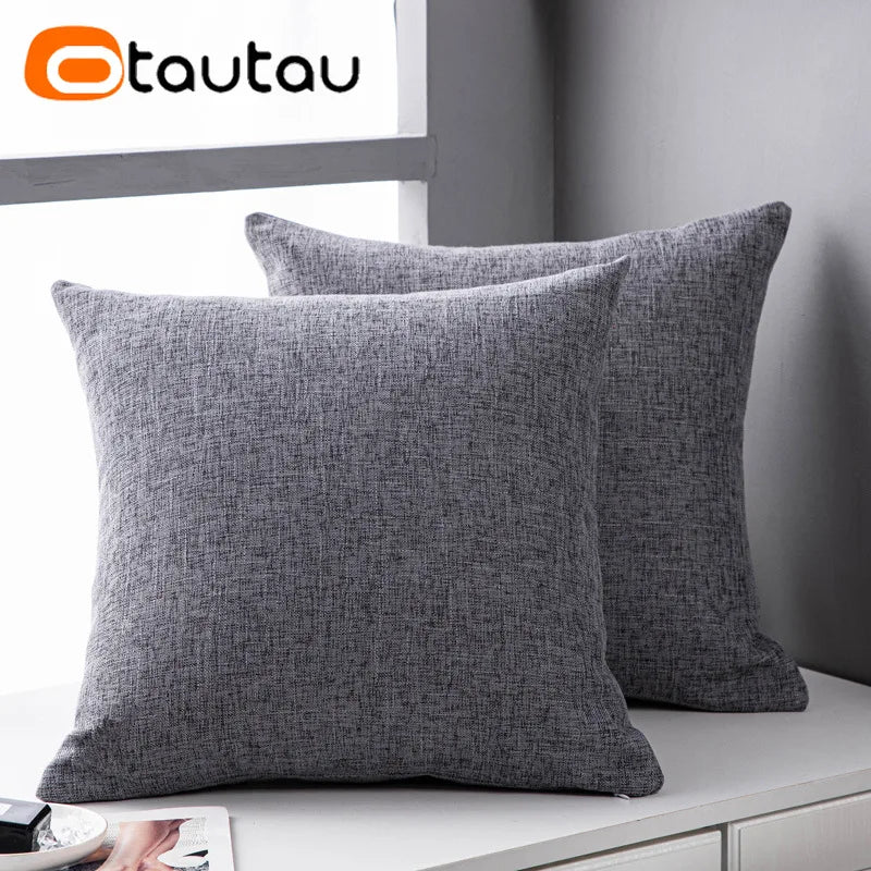 A gray linen cushion cover with a button closure is displayed on a white surface.