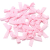 A pile of pink satin ribbon bows for craft and decoration