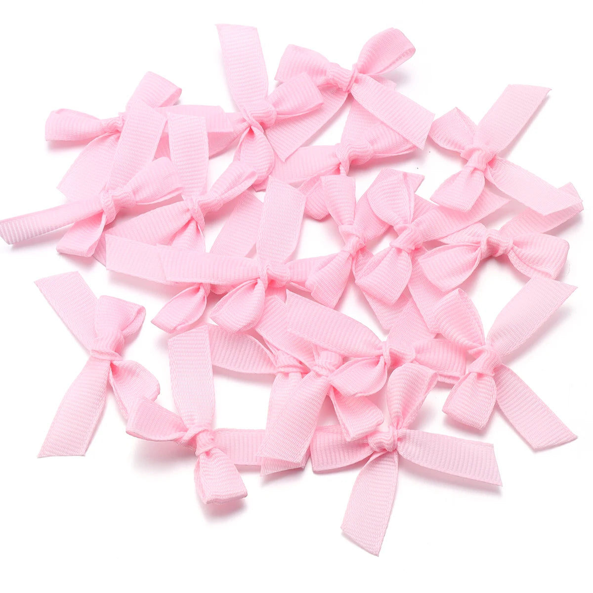 A pile of pink satin ribbon bows for craft and decoration