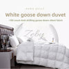 A white goose down duvet is displayed on a bed, featuring a quilted texture and a headboard.