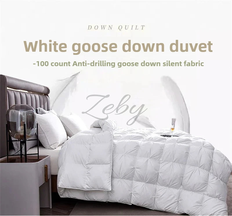 A white goose down duvet is displayed on a bed, featuring a quilted texture and a headboard.