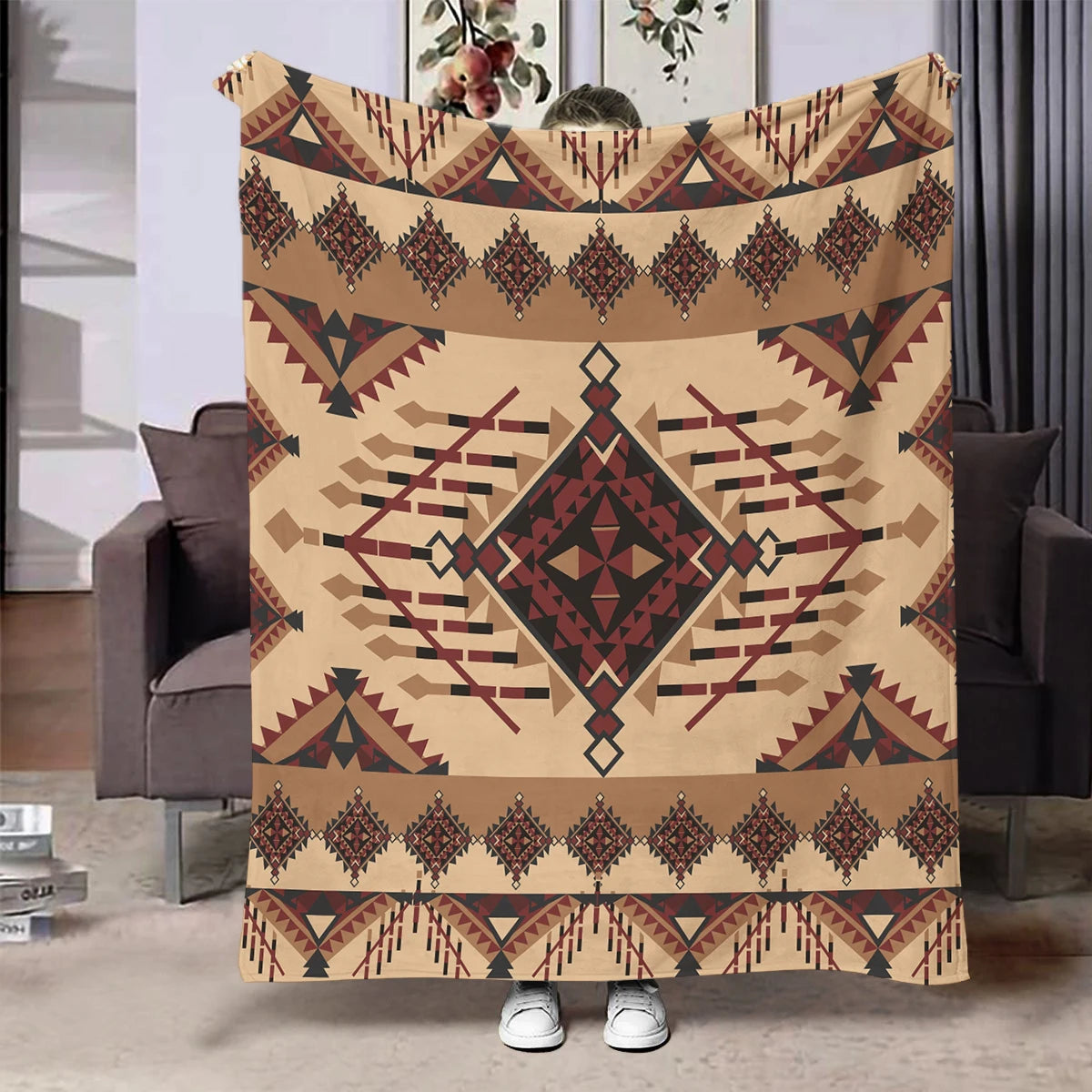 A beige flannel throw blanket featuring an ethnic geometric print in brown and maroon tones.