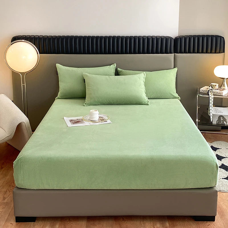 A luxury velvet bedding set featuring a sage green duvet and matching pillows on a bed.
