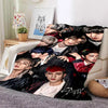 A collage of multiple Stray Kids members in various poses and outfits printed on a fleece throw blanket.