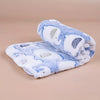 A rolled white and blue flannel pet blanket with elephant print for dogs and cats.