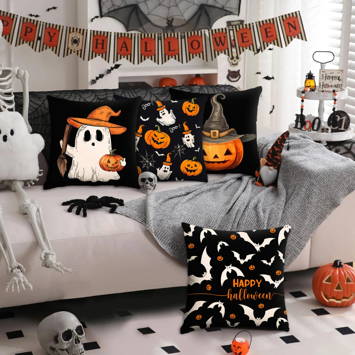 A set of black and orange Halloween themed pillow covers decorating a living room with seasonal banners and pumpkins.