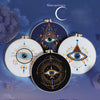 Hand embroidery starter kit featuring various star and eye patterns on round fabric pieces.