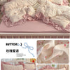 Pink princess style bedding set featuring floral patterns and ruffled edges on a white wooden bed frame.