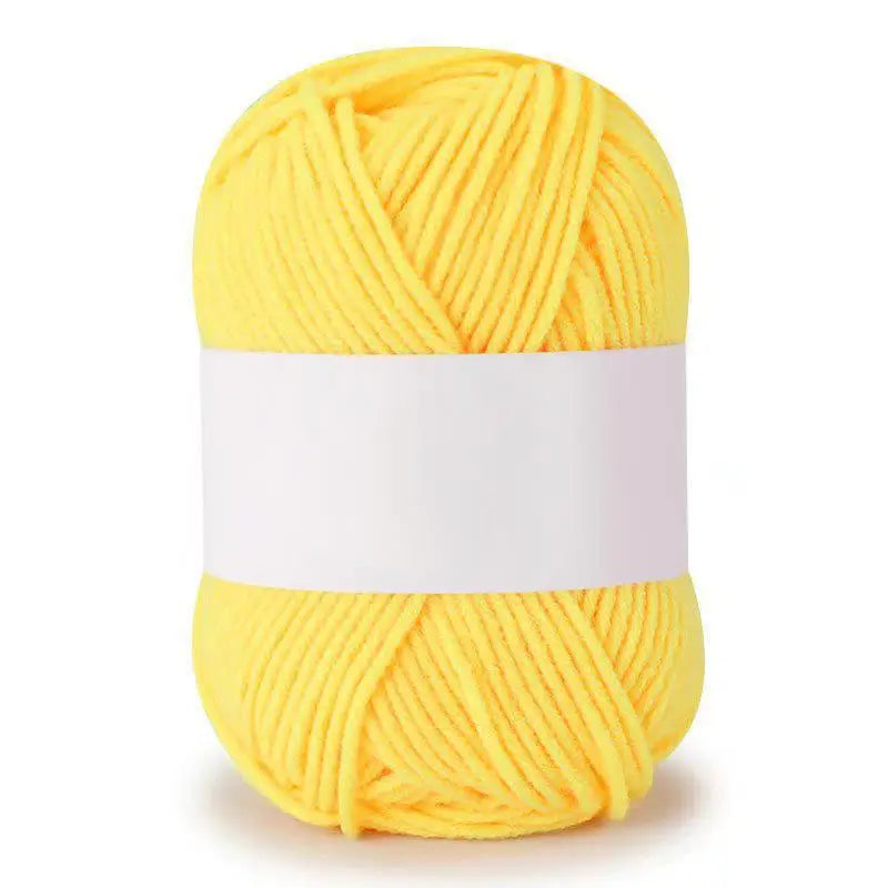 A ball of bright yellow soft milk cotton knitting yarn