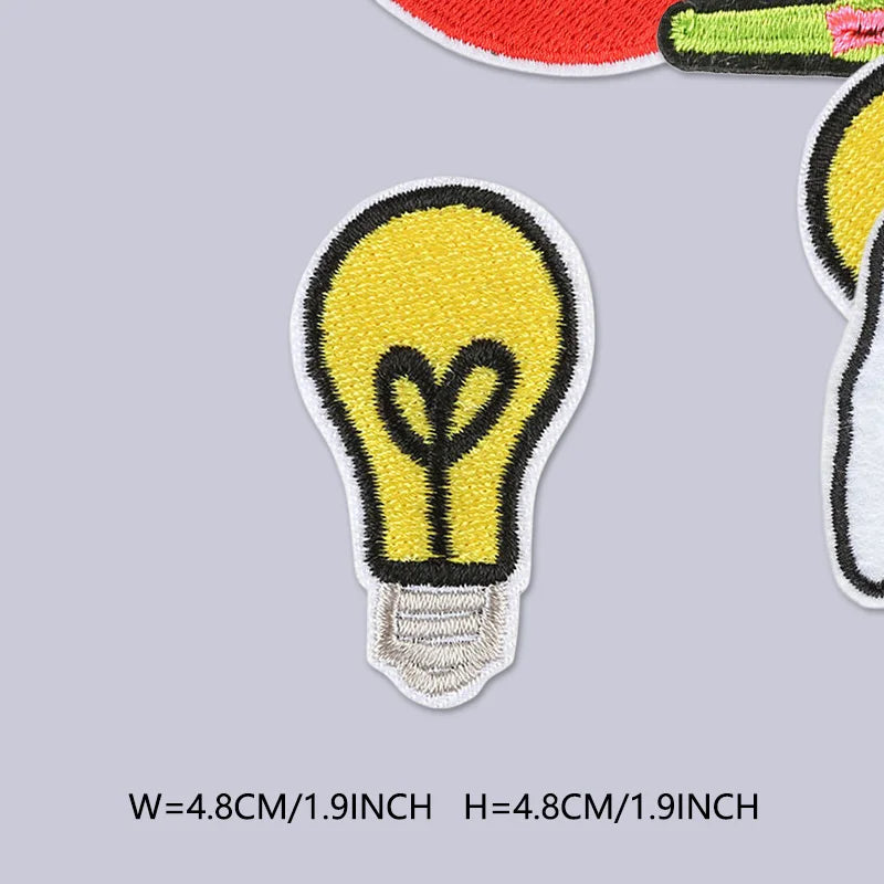 A yellow lightbulb shaped iron-on or sew-on embroidered patch for clothing.