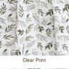 Close-up of a white muslin swaddle blanket featuring a clear print of green leafy branches.
