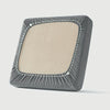 A square sofa seat slipcover in beige fabric with a dark gray checkered trim.