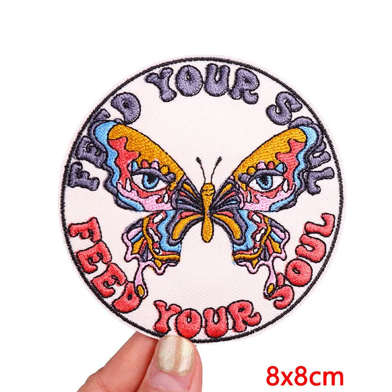 An embroidered patch featuring a butterfly design with the text Your Feel Your Soul on a light background.