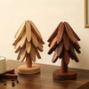Two wooden tree-shaped placemats are displayed on a dark wood table.
