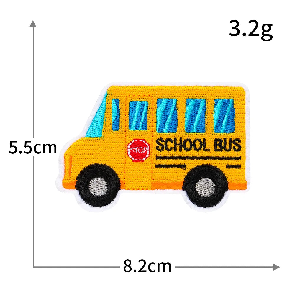 A yellow school bus patch with blue windows and black wheels, measuring 3.2g and 5.5cm high.