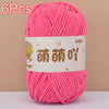 A skein of bright pink soft bulky chenille yarn is shown on a light background.
