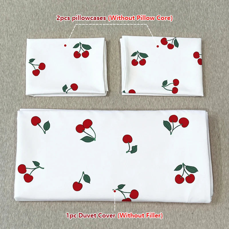 A set of two pillowcases without a core and one duvet cover without filler featuring a fruit print design.