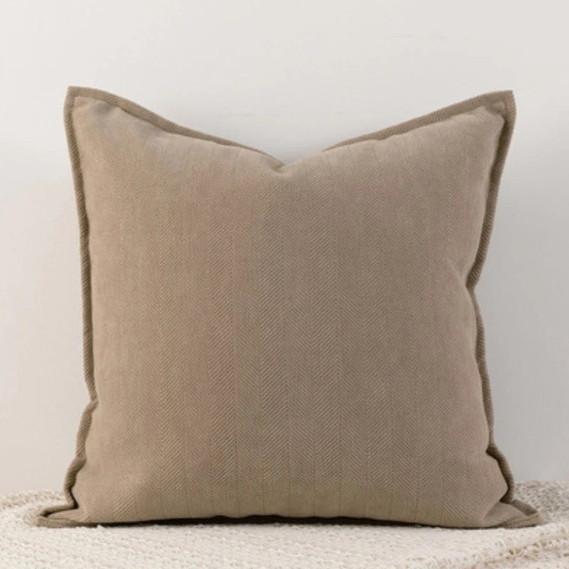 A solid beige chenille throw pillow cover with a subtle vertical texture.