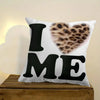 A decorative pillow cover featuring the text I ME and a leopard print heart design on a white background.