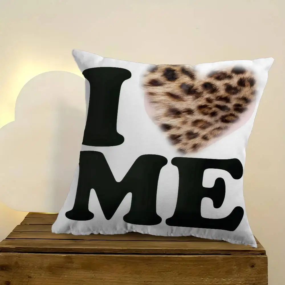 A decorative pillow cover featuring the text I ME and a leopard print heart design on a white background.