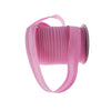 Pink durable bias tape binding ribbon rolled into a cylindrical shape.