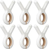 A set of white heavy-duty plastic clothespins with rust-resistant springs shown in various angles.