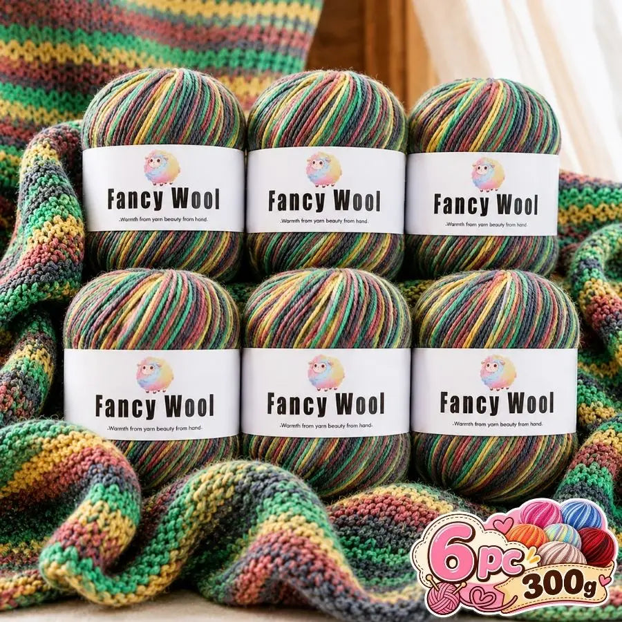 A set of six balls of fancy wool yarn in various gradient colors stacked on a surface.