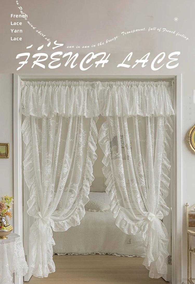 White sheer French lace curtains with delicate ruffles framing a bedroom window.
