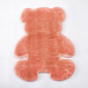 A plush, pinkish-orange bear-shaped non-slip area rug.