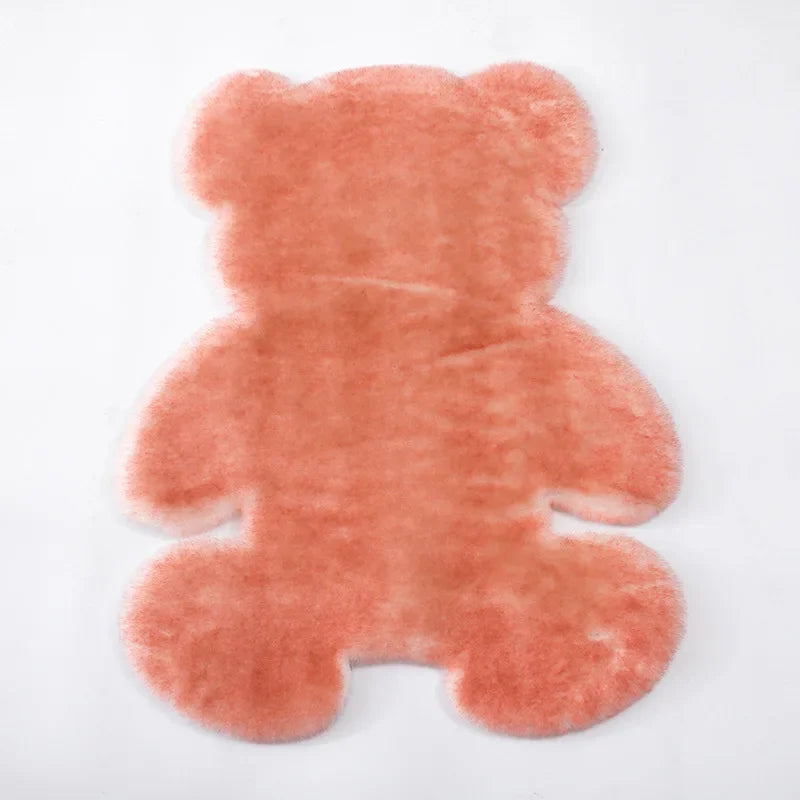 A plush, pinkish-orange bear-shaped non-slip area rug.