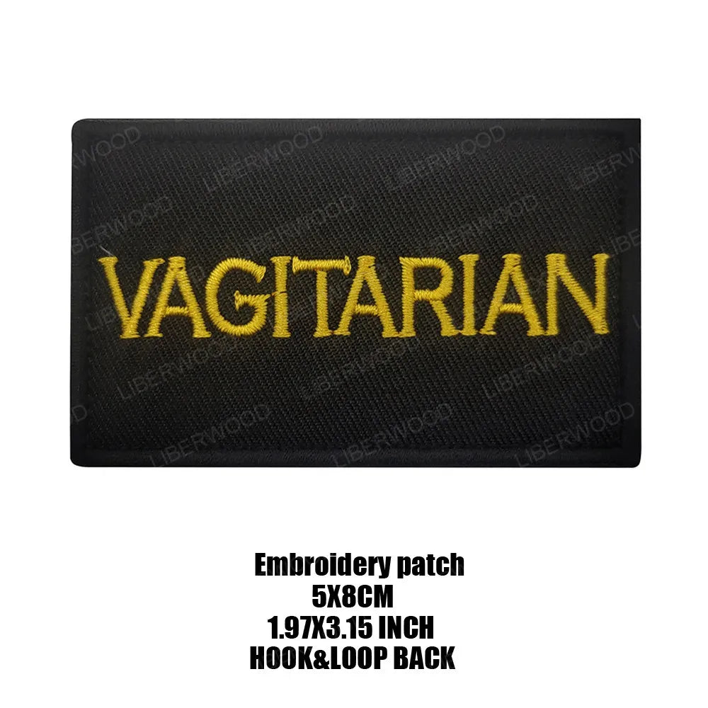 Black embroidered patch with the word VEGETARIAN in yellow thread